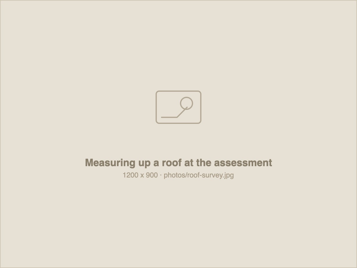 An Annergy assessor measuring up a roof during a site assessment.